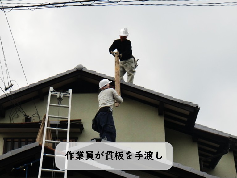 熊取町で作業員が貫板を手渡し